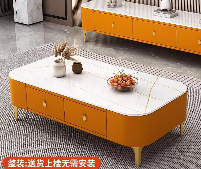 Modern rectangular coffee table featuring a white faux-marble tabletop, orange upholstered storage drawers, and gold legs